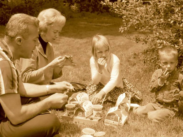 Picnickers enjoy chicken snacks from the Red Barn, a local restaurant chain, 1964