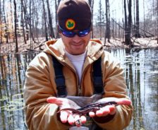 Park district employee Ramsey Langford poses with yellow-spotted salamanders at Wood Hollow Metro Park