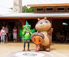 Mascots pose in front of Liberty Park Nature Center, 2014