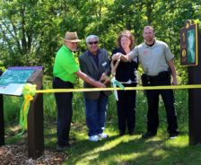 Lisa King cuts the ribbon for the Disc Golf Course at Silver Creek Metro Park, 2019